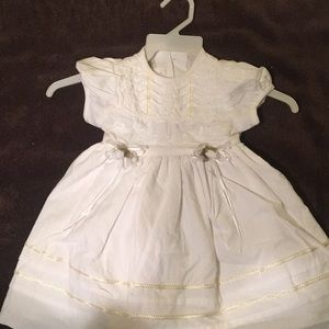 Baby girl’s white dress with diaper pantaloons.
